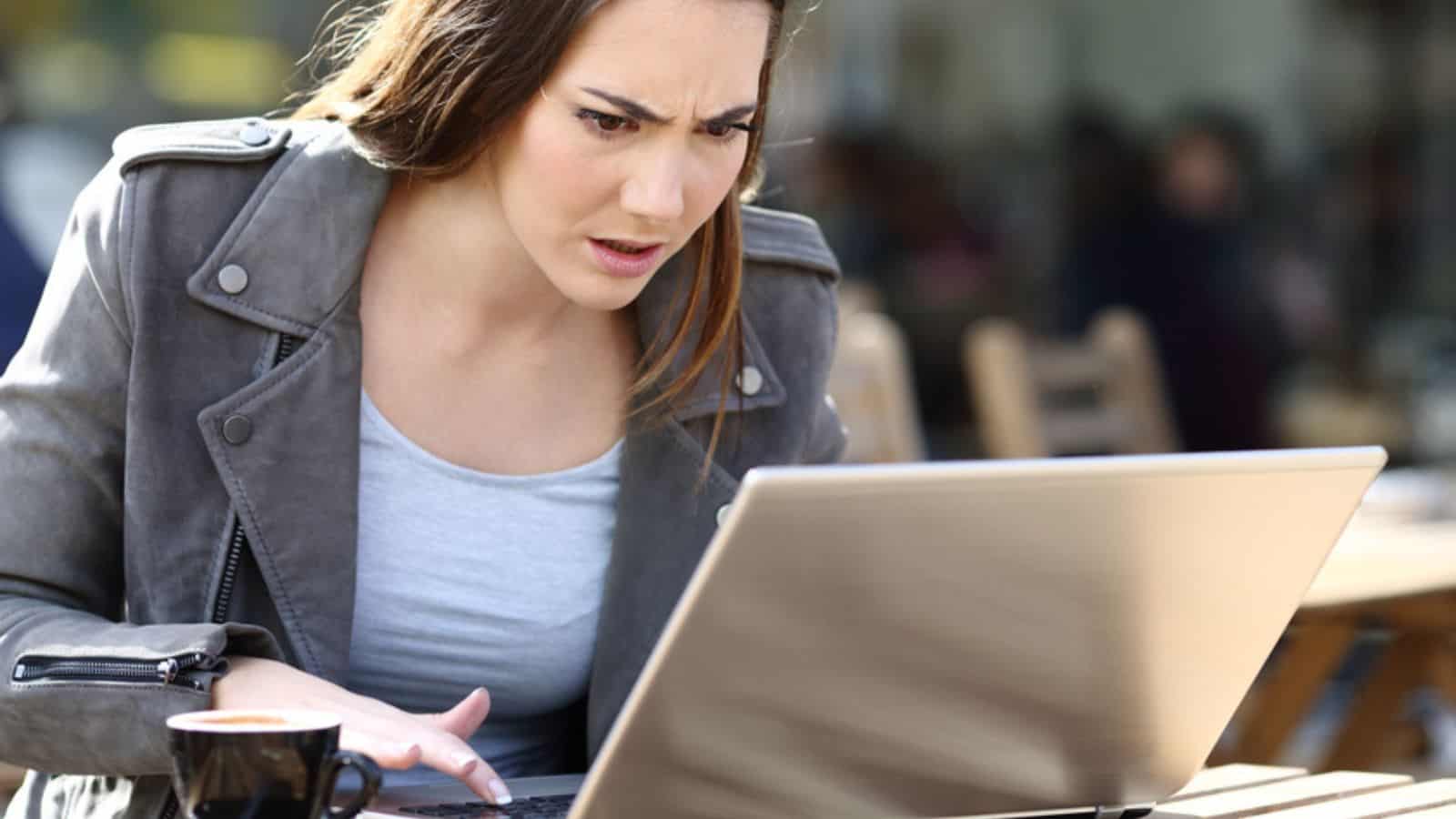 Angry woman looking at her laptop