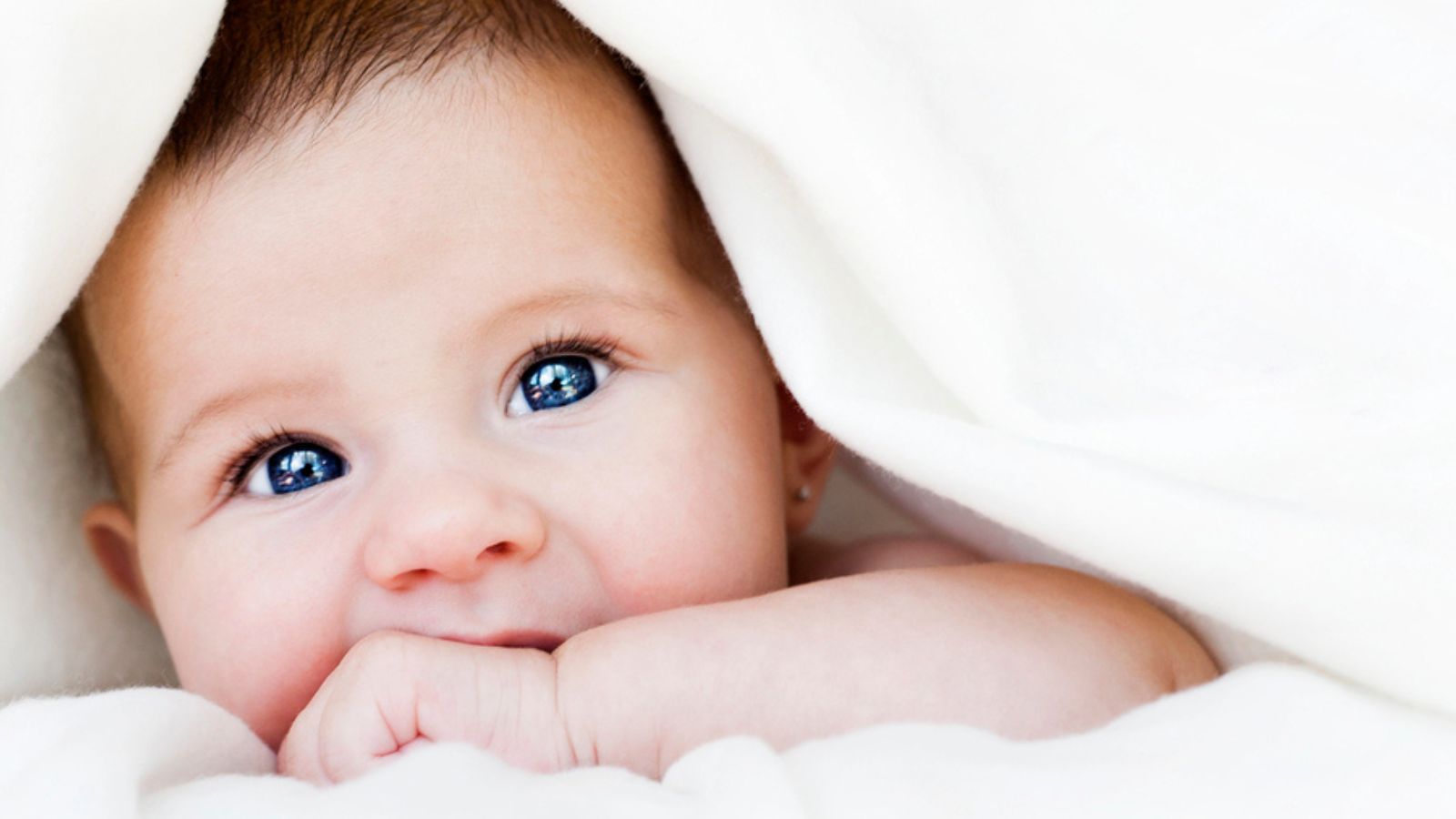 Baby under blanket