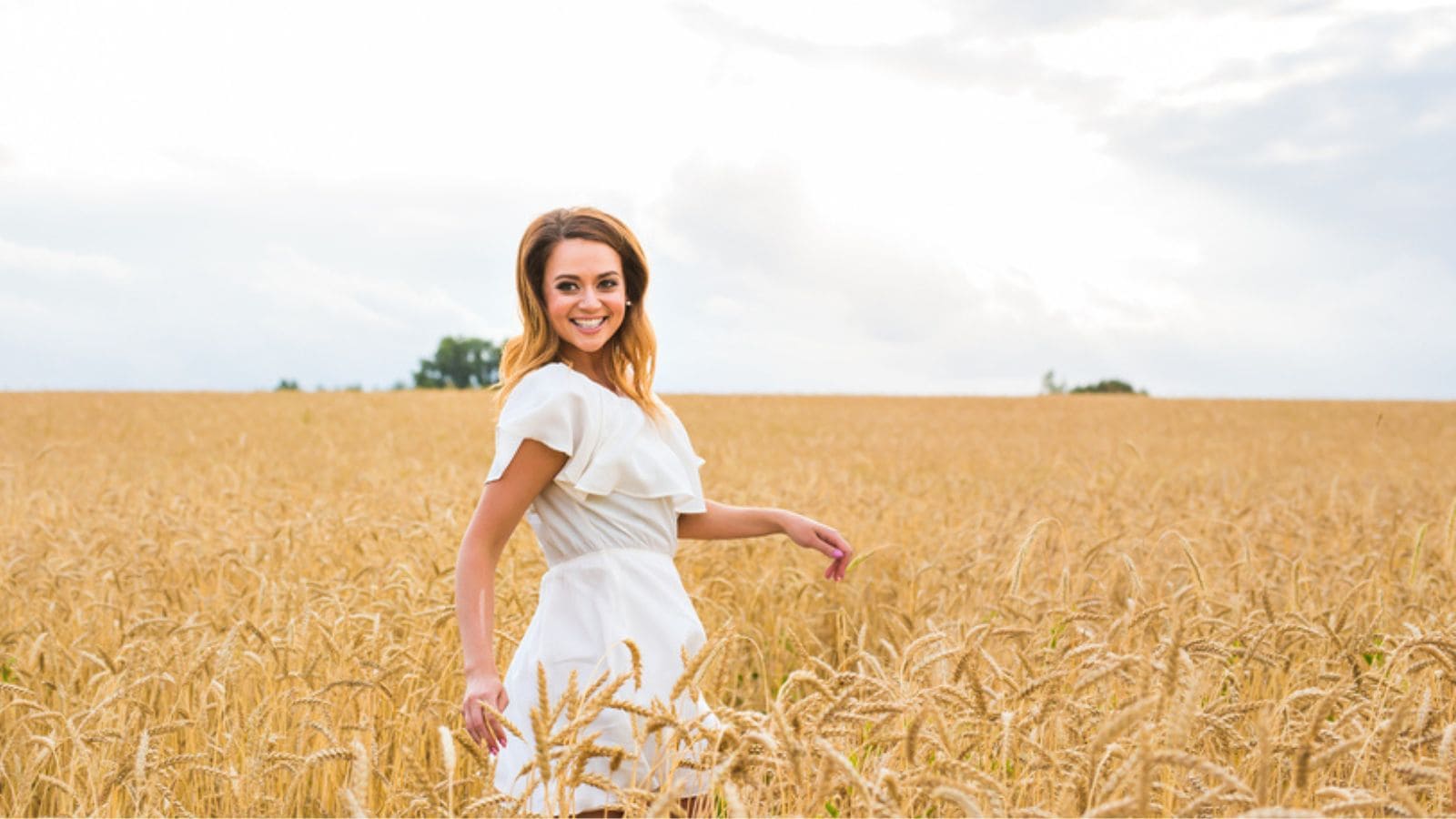 Beautiful woman Outdoors enjoying nature on the Field