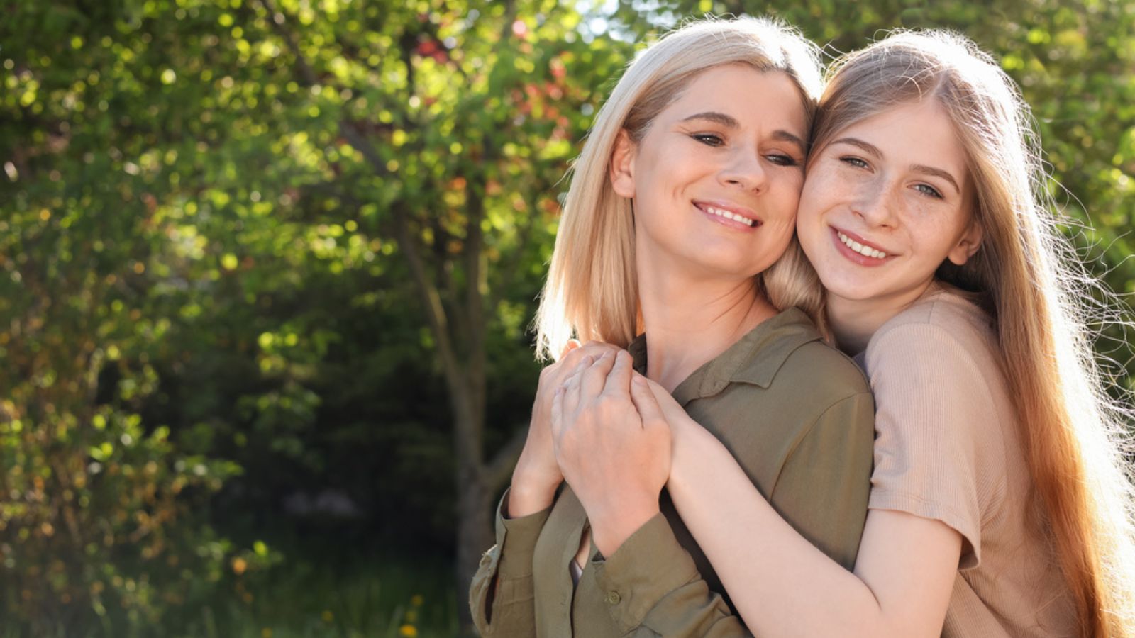 Happy mother with her daughter spending time together in park on sunny day