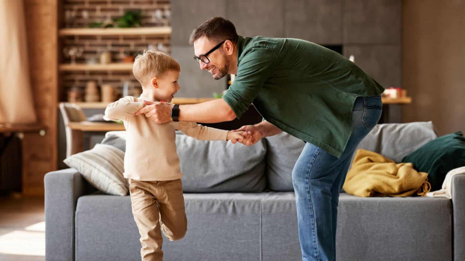 Laughing dad and son at home