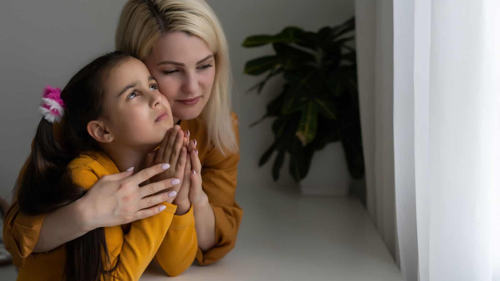 Mom and daughter praying