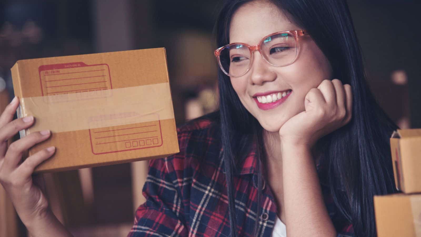 woman holding a shopping box working from home