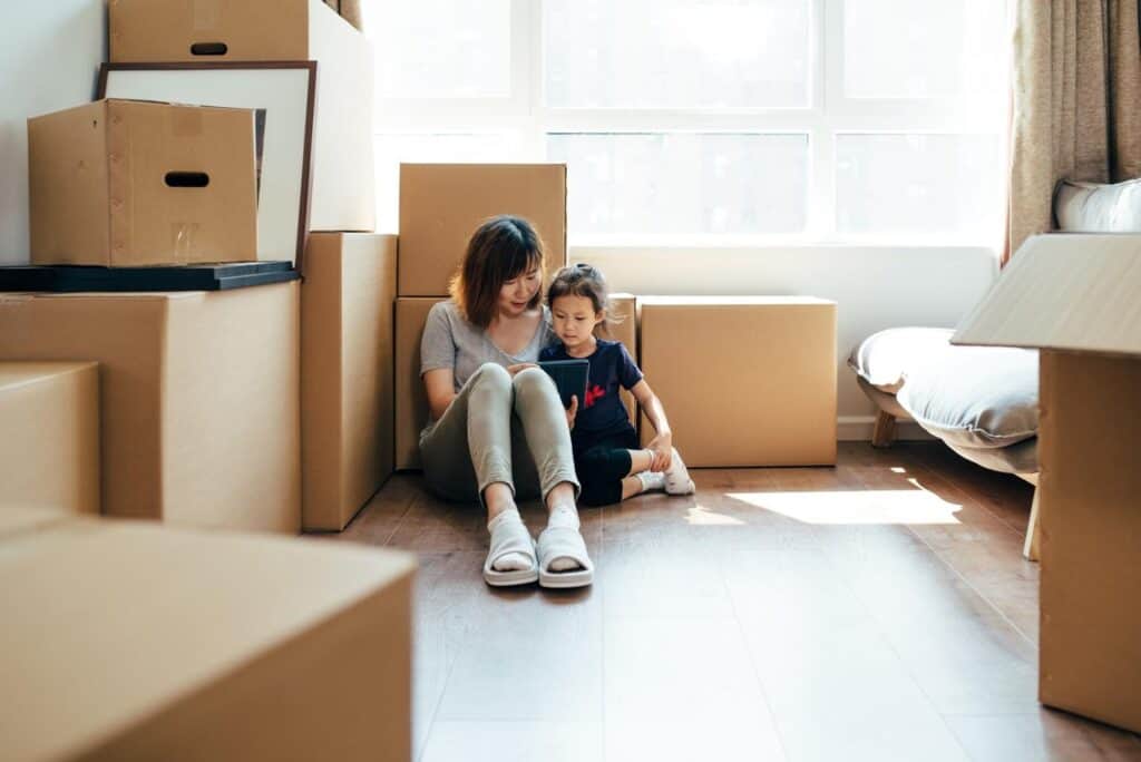 mom and daughter moving with boxes