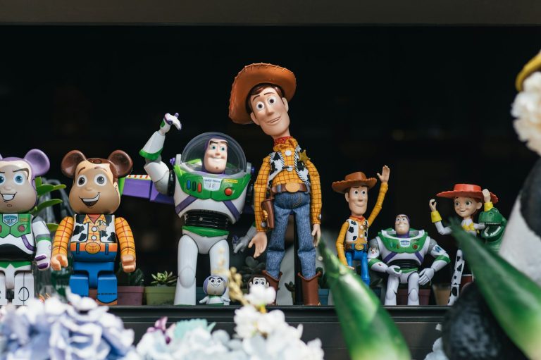 A bunch of toy figurines that are on a table; throwback kid toys