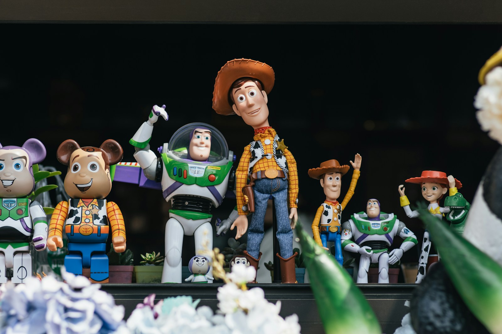 A bunch of toy figurines that are on a table; throwback kid toys