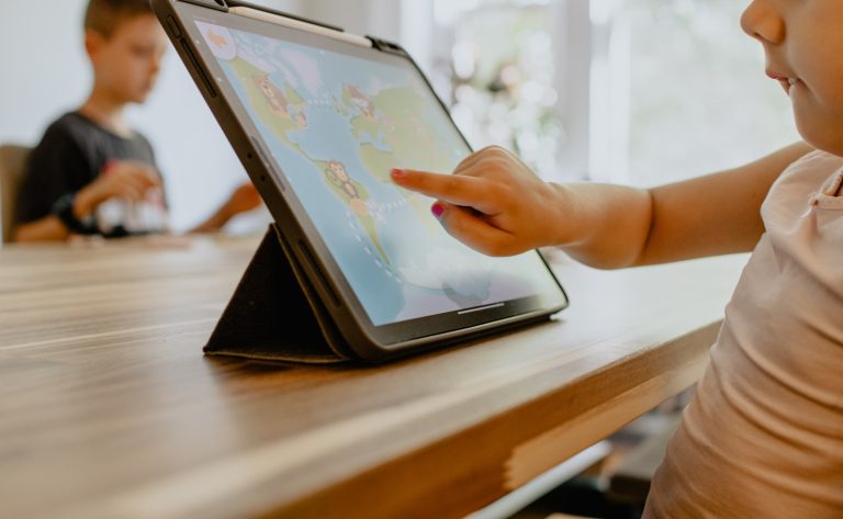 person using white tablet computer; how much screen time is recommended