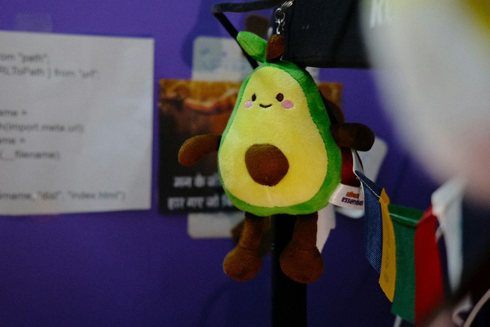 A plush avocado keychain with a smiling face; backpack charms
