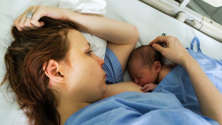 woman breastfeed the baby; postpartum recovery