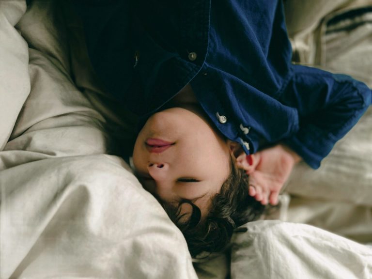 a person lying on a bed; nap transition
