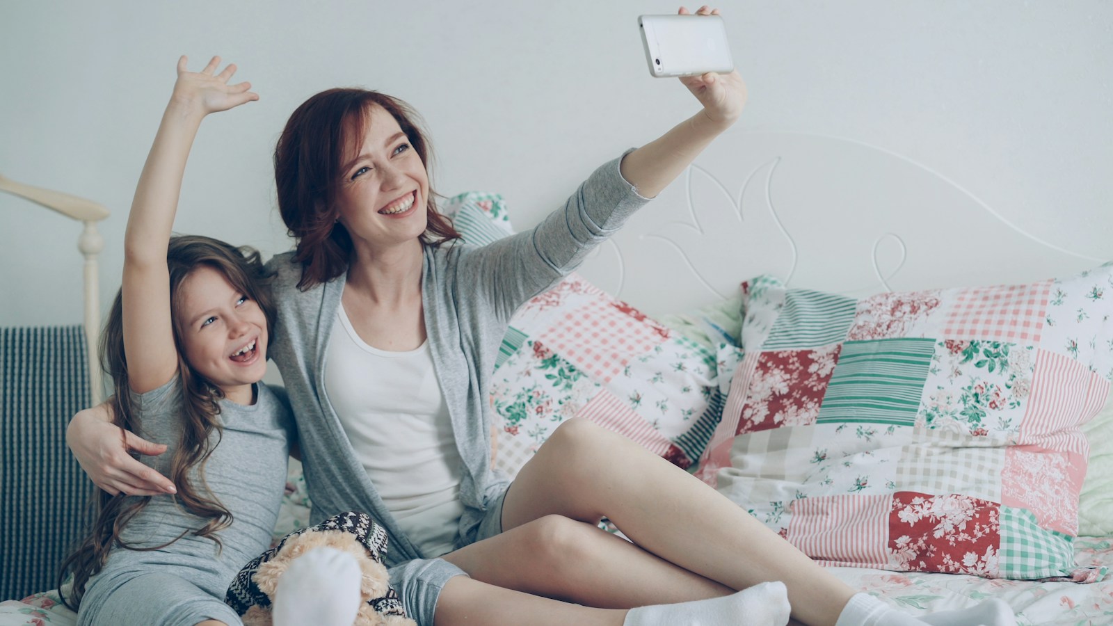 Mother and daughter happily take a selfie together; kidfluencer laws