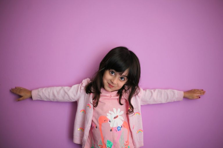 girl in pink and white floral long sleeve shirt; positive discipline strategies