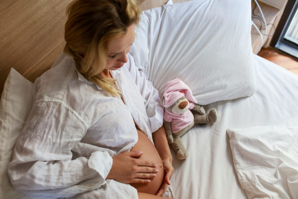 a person holding a stuffed animal; postpartum recovery