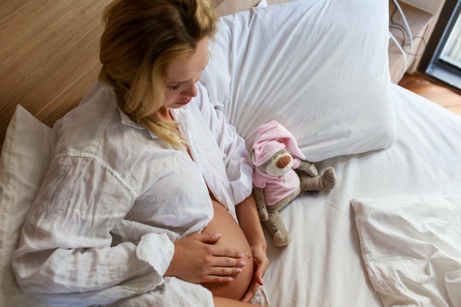 a person holding a stuffed animal; postpartum recovery