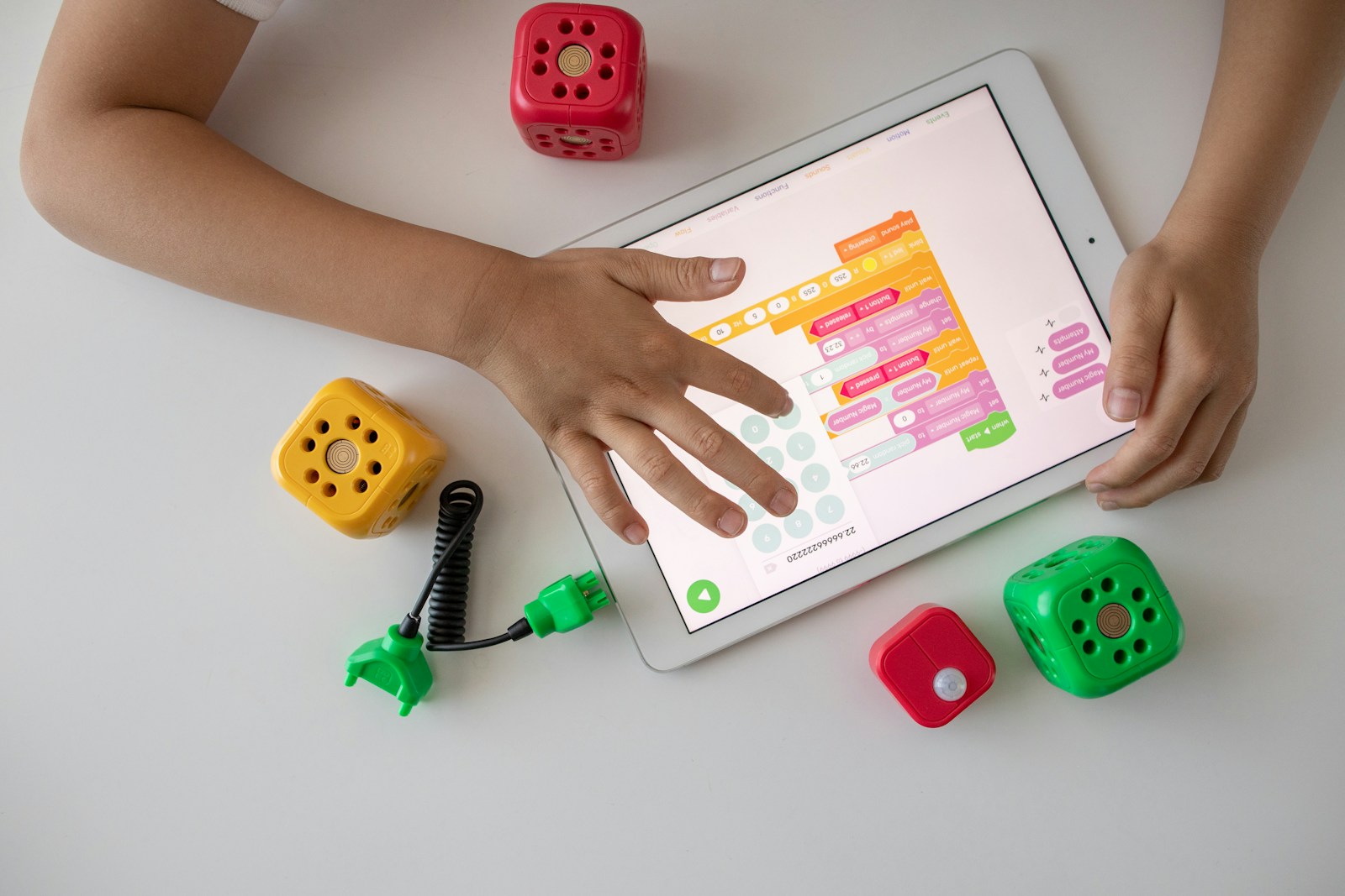 person holding white ipad on white table; dopamine menu for kids