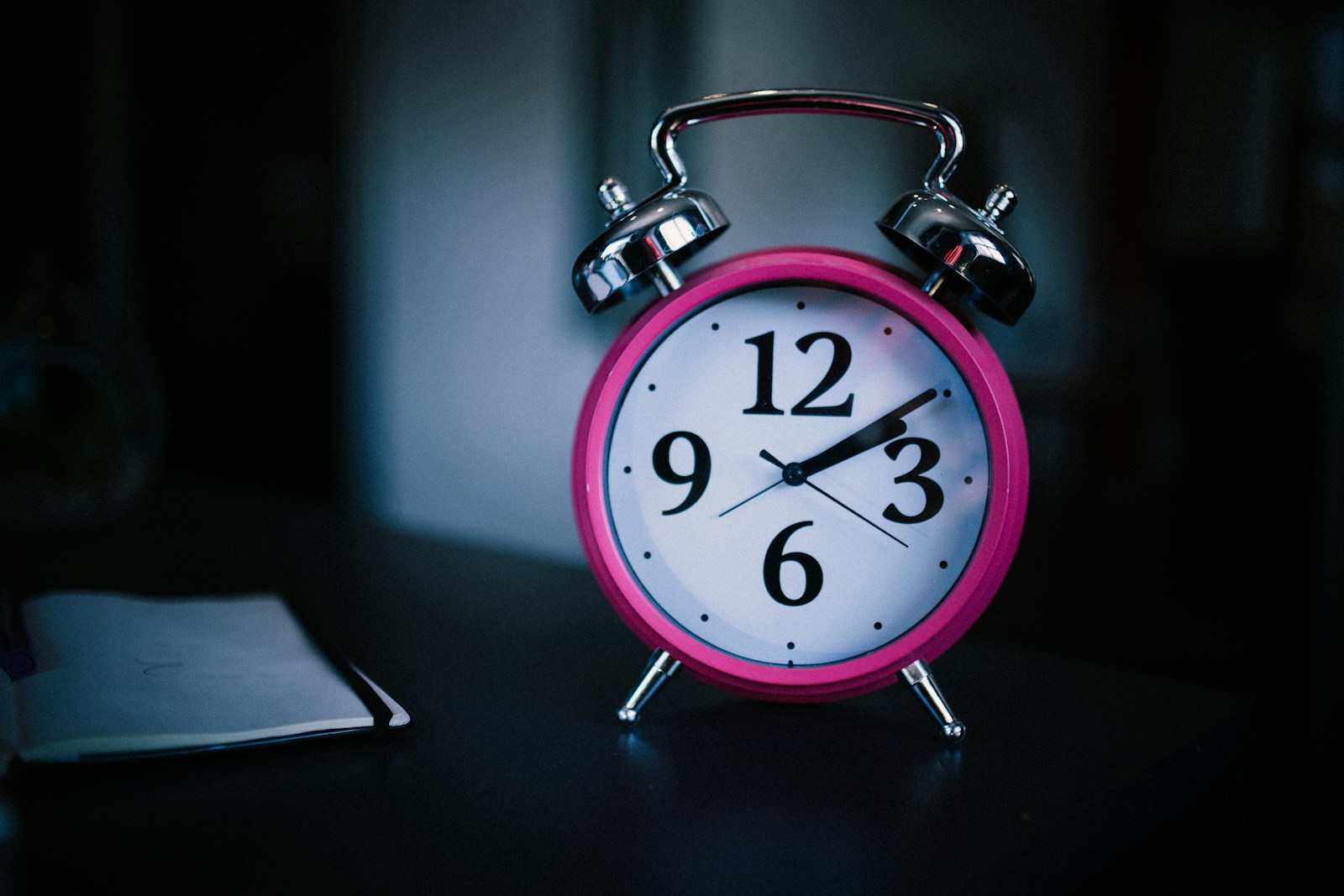 pink bell alarm clock showing 2:10; daylight saving time