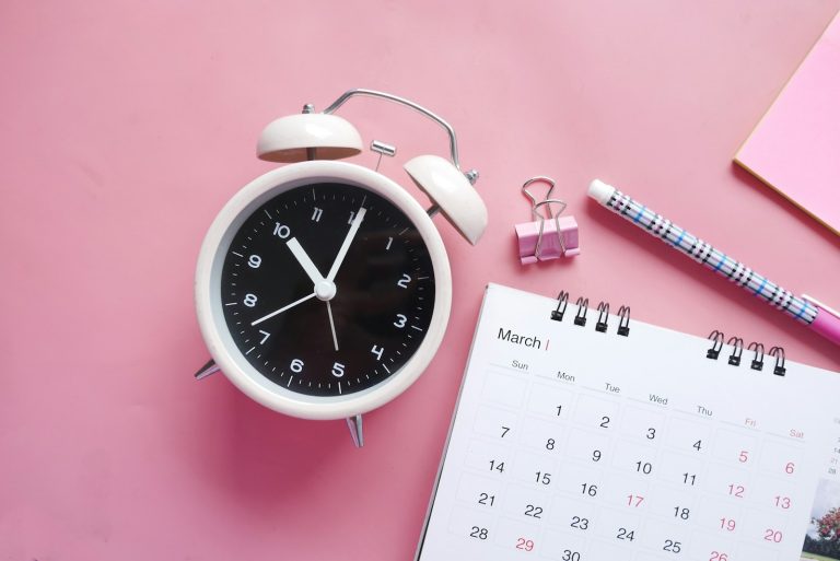 white and pink analog alarm clock; daylight saving time