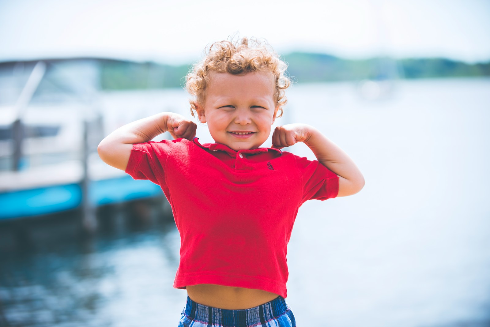 boy standing near dock; strong willed