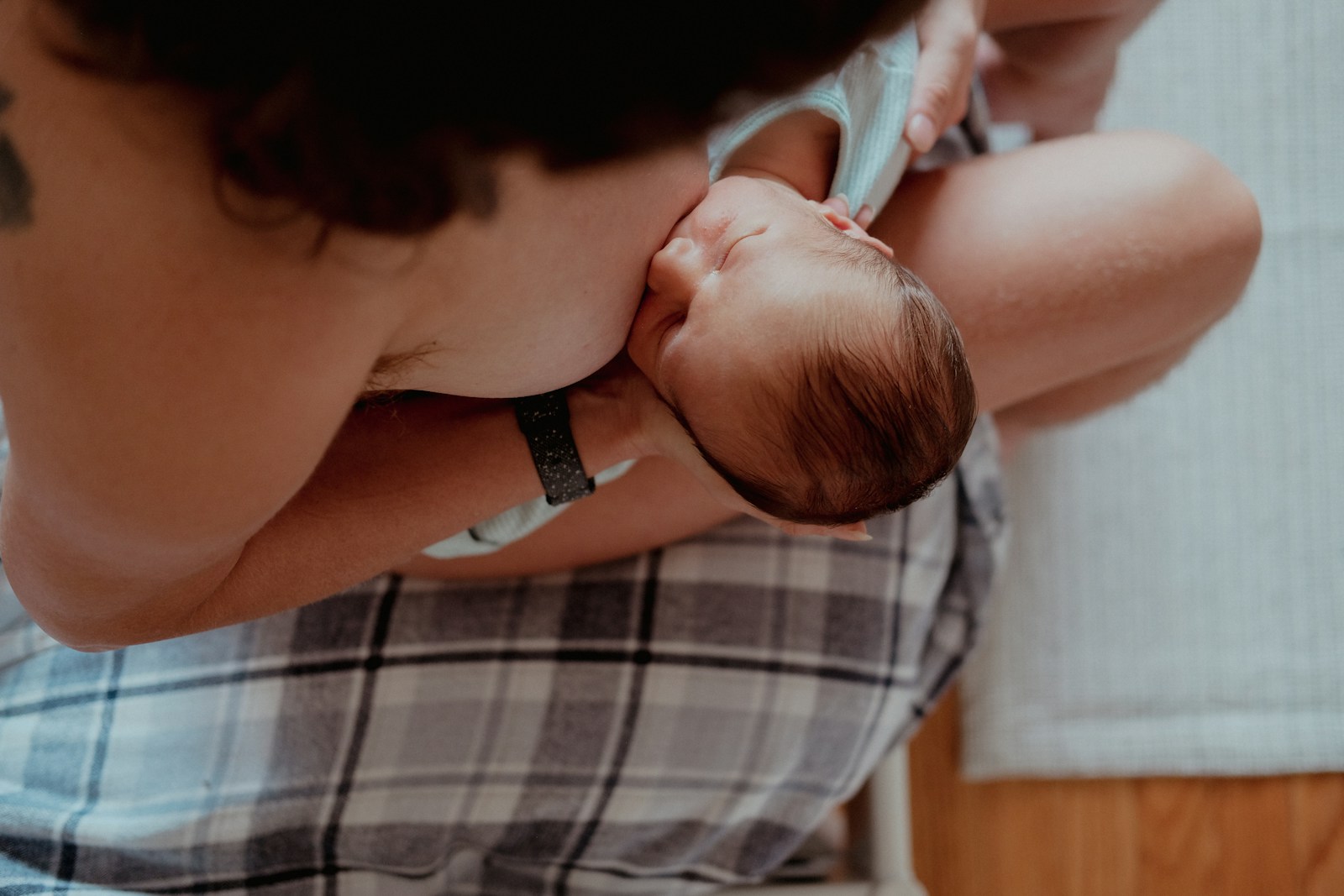 a woman holding a baby in her lap; breast milk