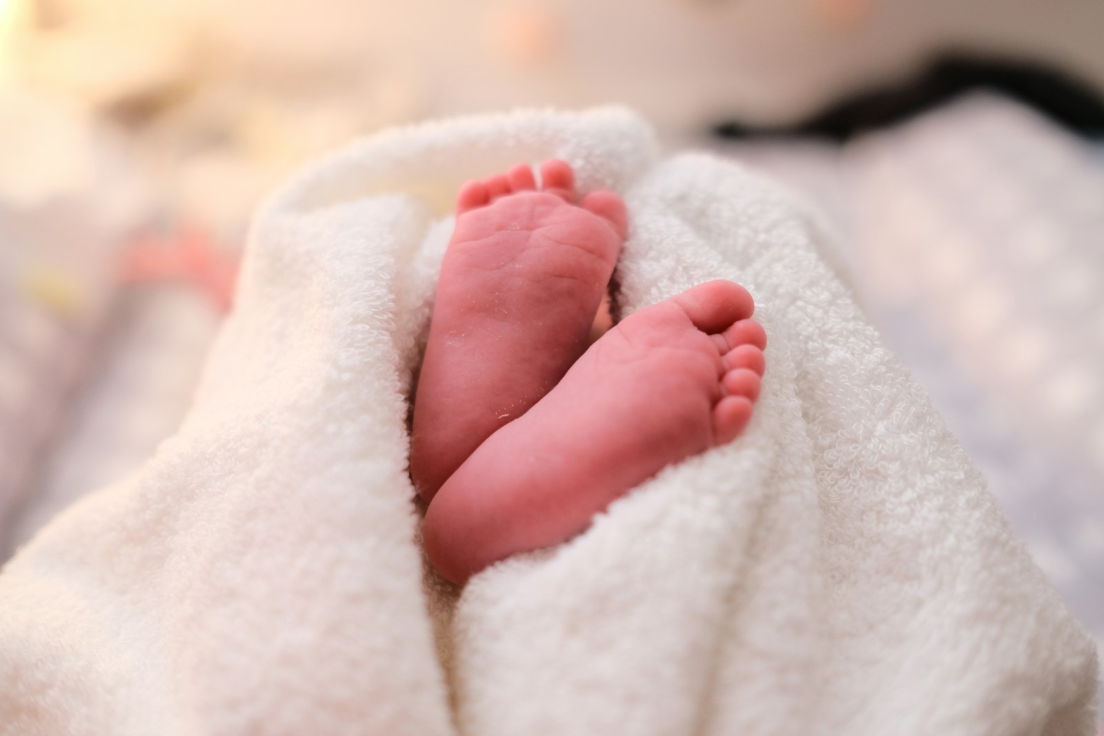 baby covered with white blanket; baby name trends 2026