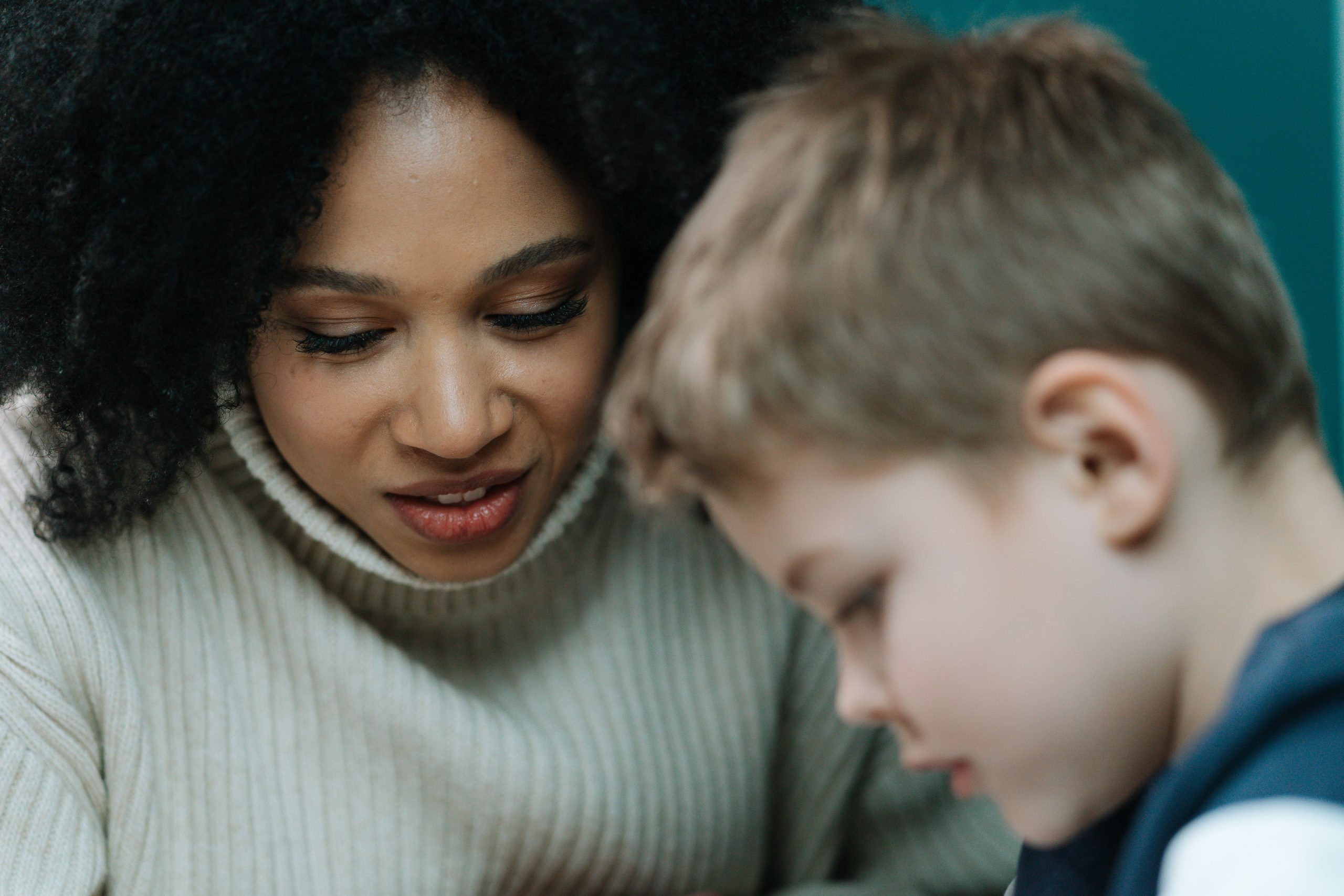 Mother talking patiently with her young son who is working through a stutter