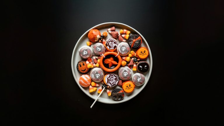a white plate topped with lots of halloween candies; Halloween candy safety