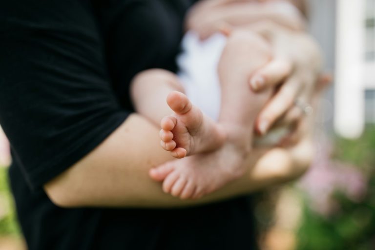 person carrying baby on arms; increase breast milk supply