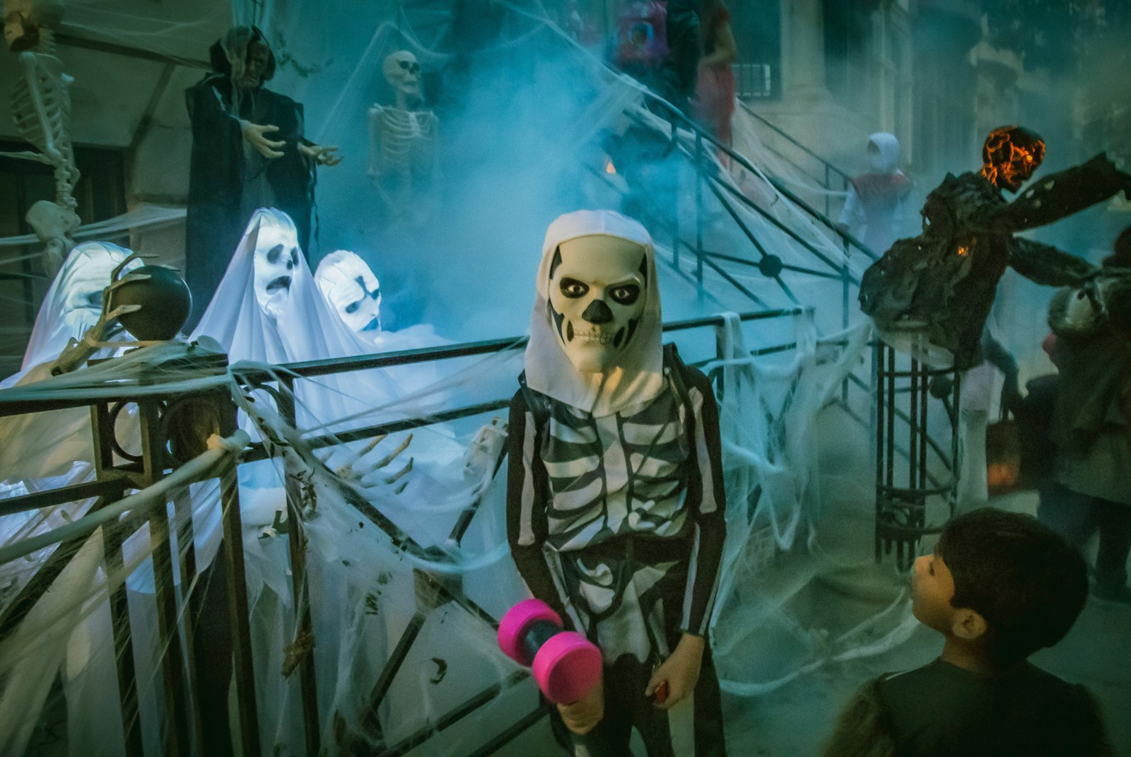 person in white mask standing beside white robot; halloween anxiety in kids