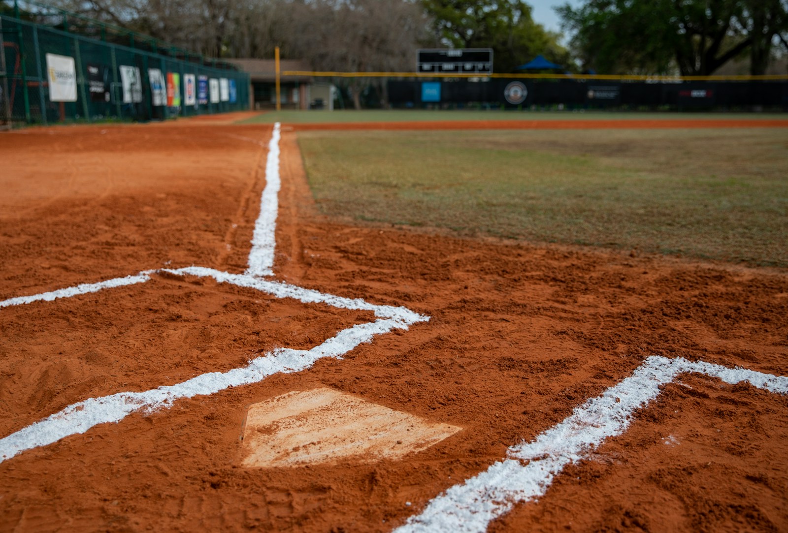 a baseball field with a diamond and a baseball field in the background; youth sports